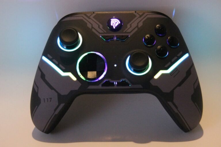 EasySMX X15 gaming controller with RGB lighting powered on, showing dual joysticks, D-pad, and illuminated design. Reviewed by Gaming Extra Reviews.