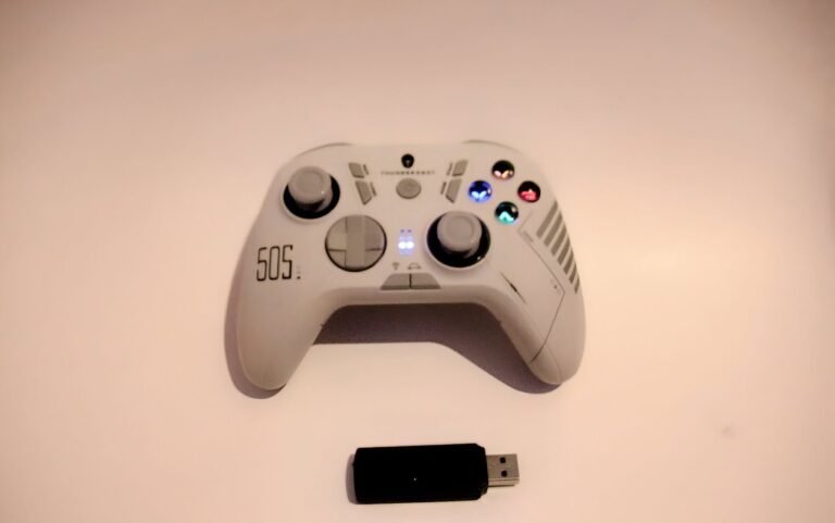 Thunderobot G50S wireless gaming controller with LED indicators and included USB dongle displayed on a flat surface.