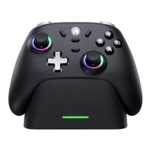Close-up of a black game controller showing two glowing analog sticks, a silver D-pad, and A/B/X/Y buttons on a white background, with a green light at the bottom edge.