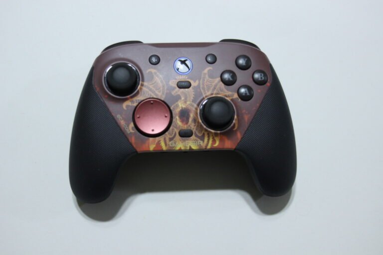 Xbox-style wireless game controller with a maroon dragon-themed faceplate, two thumbsticks, D-pad, and A/B/X/Y buttons on a light background.